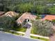 Stunning aerial view of a single-Gathering home with a tile roof, lush landscaping, and a paver driveway at 7533 Trillium Blvd, Sarasota, FL 34241