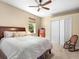 Bedroom with a bed, closet, and natural light from the window. A rocking chair is next to the bed at 7533 Trillium Blvd, Sarasota, FL 34241