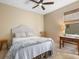 Cozy bedroom featuring a queen-size bed, ceiling fan, and natural light from the window at 7533 Trillium Blvd, Sarasota, FL 34241
