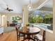Cozy breakfast nook with views of the screened pool, hardwood floors, and open to the living area at 7533 Trillium Blvd, Sarasota, FL 34241
