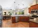 Modern kitchen with stainless steel appliances, sleek countertops, dark wood cabinets, and a view to the living space at 7533 Trillium Blvd, Sarasota, FL 34241