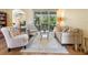 Comfortable living room with sliding glass doors to the lanai, hardwood floors, and stylish furniture at 7533 Trillium Blvd, Sarasota, FL 34241