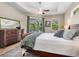 Relaxing main bedroom with tray ceiling, ceiling fan, en-suite bathroom, and large windows for natural light at 7533 Trillium Blvd, Sarasota, FL 34241