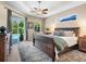 Spacious main bedroom with tray ceiling, ceiling fan, en-suite bathroom, and access to the screened-in patio at 7533 Trillium Blvd, Sarasota, FL 34241