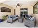 Comfortable outdoor patio with ceiling fan, contemporary furniture, and backyard views at 7533 Trillium Blvd, Sarasota, FL 34241