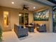 Inviting outdoor patio featuring comfortable seating, ceiling fan, and views of the lush landscape at 7533 Trillium Blvd, Sarasota, FL 34241