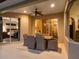 Relaxing covered patio with wicker dining set, ceiling fan, and view of the adjacent living room and bedroom at 7533 Trillium Blvd, Sarasota, FL 34241