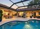 Stunning outdoor pool with an expansive screened-in lanai, lounge seating, and patio dining area at 7533 Trillium Blvd, Sarasota, FL 34241