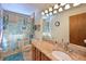 Updated bathroom featuring vanity with granite countertop and tub with themed shower curtain at 7816 15Th Nw Ave, Bradenton, FL 34209