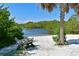Tranquil beach view with clear blue water and a relaxing cross-legged bench at 7816 15Th Nw Ave, Bradenton, FL 34209
