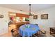 Comfortable dining room showcases a chandelier, a view to the outside, and a passthrough to the kitchen at 7816 15Th Nw Ave, Bradenton, FL 34209
