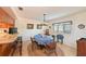 Casual dining area features a chandelier, wainscoting, a view to the outside, and a breakfast bar at 7816 15Th Nw Ave, Bradenton, FL 34209
