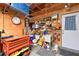 Functional garage area equipped with a work sink, multiple storage shelves, and a convenient side door at 7816 15Th Nw Ave, Bradenton, FL 34209