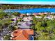 Scenic aerial view of lakeside homes with tiled roofs and mature trees, offering a beautiful community setting at 8224 Waterview Blvd, Lakewood Ranch, FL 34202