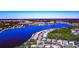 Aerial view showcasing a waterfront community, a large lake and lush landscaping at 8224 Waterview Blvd, Lakewood Ranch, FL 34202