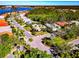 Aerial view of homes in a scenic neighborhood with mature trees, lush landscaping, and a large lake in the background at 8224 Waterview Blvd, Lakewood Ranch, FL 34202