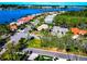 Aerial view of a community's tiled-roof houses, scenic lakefront, and lush trees on a bright sunny day at 8224 Waterview Blvd, Lakewood Ranch, FL 34202