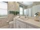 Bright bathroom featuring vanity, sink, toilet, and decorative accents at 8224 Waterview Blvd, Lakewood Ranch, FL 34202