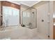 Bright bathroom featuring tiled tub with window and separate glass enclosed shower at 8224 Waterview Blvd, Lakewood Ranch, FL 34202