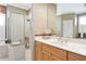 Bright bathroom with double sink vanity, large mirror and walk-in shower at 8224 Waterview Blvd, Lakewood Ranch, FL 34202