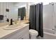 Clean bathroom featuring a white vanity, modern fixtures, and a shower with a gray curtain at 8224 Waterview Blvd, Lakewood Ranch, FL 34202