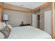 Neutral bedroom featuring a four poster bed and closet at 8224 Waterview Blvd, Lakewood Ranch, FL 34202