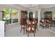 Bright dining room featuring a wooden table set, mirrored wall, and lush outdoor view at 8224 Waterview Blvd, Lakewood Ranch, FL 34202