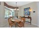 Bright dining room with wooden table, stylish window treatments, and elegant furniture at 8224 Waterview Blvd, Lakewood Ranch, FL 34202
