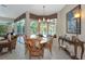 Charming dining area with bay window and views of screened lanai, furnished with traditional wood furniture at 8224 Waterview Blvd, Lakewood Ranch, FL 34202