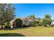 Beautiful home with lush landscaping, mature trees, and a well-maintained lawn, creating a serene setting at 8224 Waterview Blvd, Lakewood Ranch, FL 34202