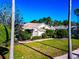 Well-maintained home with lush landscaping, mature palm trees, and a manicured lawn, offering great curb appeal at 8224 Waterview Blvd, Lakewood Ranch, FL 34202