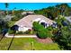 Charming single-story home featuring a well-manicured lawn, mature landscaping, and a neutral color palette at 8224 Waterview Blvd, Lakewood Ranch, FL 34202