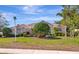 A well-kept single-Gathering home with lush landscaping, a manicured lawn, and a classic architectural style at 8224 Waterview Blvd, Lakewood Ranch, FL 34202
