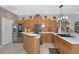 Spacious kitchen boasts stainless steel appliances, wood cabinets, mosaic backsplash, and countertop space at 8224 Waterview Blvd, Lakewood Ranch, FL 34202