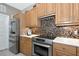 Well-equipped kitchen with stainless steel appliances, mosaic backsplash, and ample cabinet space at 8224 Waterview Blvd, Lakewood Ranch, FL 34202