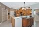Well-lit kitchen featuring wood cabinets, stainless steel appliances, mosaic backsplash, and ample storage at 8224 Waterview Blvd, Lakewood Ranch, FL 34202