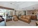Inviting living room with high ceilings, comfortable leather furniture, and view to the screened lanai at 8224 Waterview Blvd, Lakewood Ranch, FL 34202