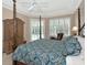 Relaxing main bedroom with a four-poster bed, bright windows, and stylish decor at 8224 Waterview Blvd, Lakewood Ranch, FL 34202