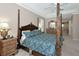 Comfortable main bedroom with a four-poster bed, dresser, and ample natural light at 8224 Waterview Blvd, Lakewood Ranch, FL 34202