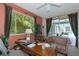 Inviting home office with a large window overlooking lush greenery and a comfortable seating area at 8224 Waterview Blvd, Lakewood Ranch, FL 34202