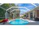 Inviting screened pool area with a spa and outdoor seating, perfect for relaxation and entertainment at 8224 Waterview Blvd, Lakewood Ranch, FL 34202