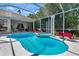 Sparkling pool with a spa and screened enclosure, surrounded by lush landscaping and outdoor living space at 8224 Waterview Blvd, Lakewood Ranch, FL 34202