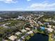 Wide aerial view of a property in a community surrounded by lakes, trees, and other neighborhood homes at 866 Placid Lake Dr, Osprey, FL 34229
