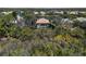 A high aerial view showcases a private home with a pool surrounded by trees and other neighborhood properties at 866 Placid Lake Dr, Osprey, FL 34229