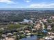 Expansive aerial view of the community, showcasing the abundance of nature, lakes, and nearby neighborhood at 866 Placid Lake Dr, Osprey, FL 34229