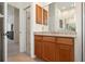 Hall bathroom with a vanity sink, a large mirror, tile floors, and paneled doors at 866 Placid Lake Dr, Osprey, FL 34229