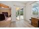 Bright room featuring light-colored flooring, wooden cabinet, a window, and a door to screened patio at 866 Placid Lake Dr, Osprey, FL 34229