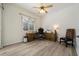 Neutral home office featuring a wooden desk, chair, ceiling fan, and light-colored flooring at 866 Placid Lake Dr, Osprey, FL 34229