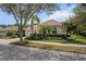 Charming single-story home with a paved driveway, tile roof, two-car garage, and professionally landscaped yard at 866 Placid Lake Dr, Osprey, FL 34229