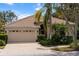 Lovely home features a paved driveway, tile roof, lush landscaping, and an attached two-car garage at 866 Placid Lake Dr, Osprey, FL 34229